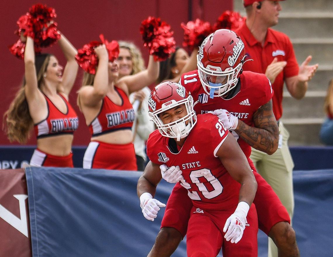 Fresno State’s Ronnie Rivers celebrates with teammate Josh Kelly after scoring a touchdown in the first half of their game against Nevada at Bulldog Stadium on Saturday, Oct. 23, 2021.