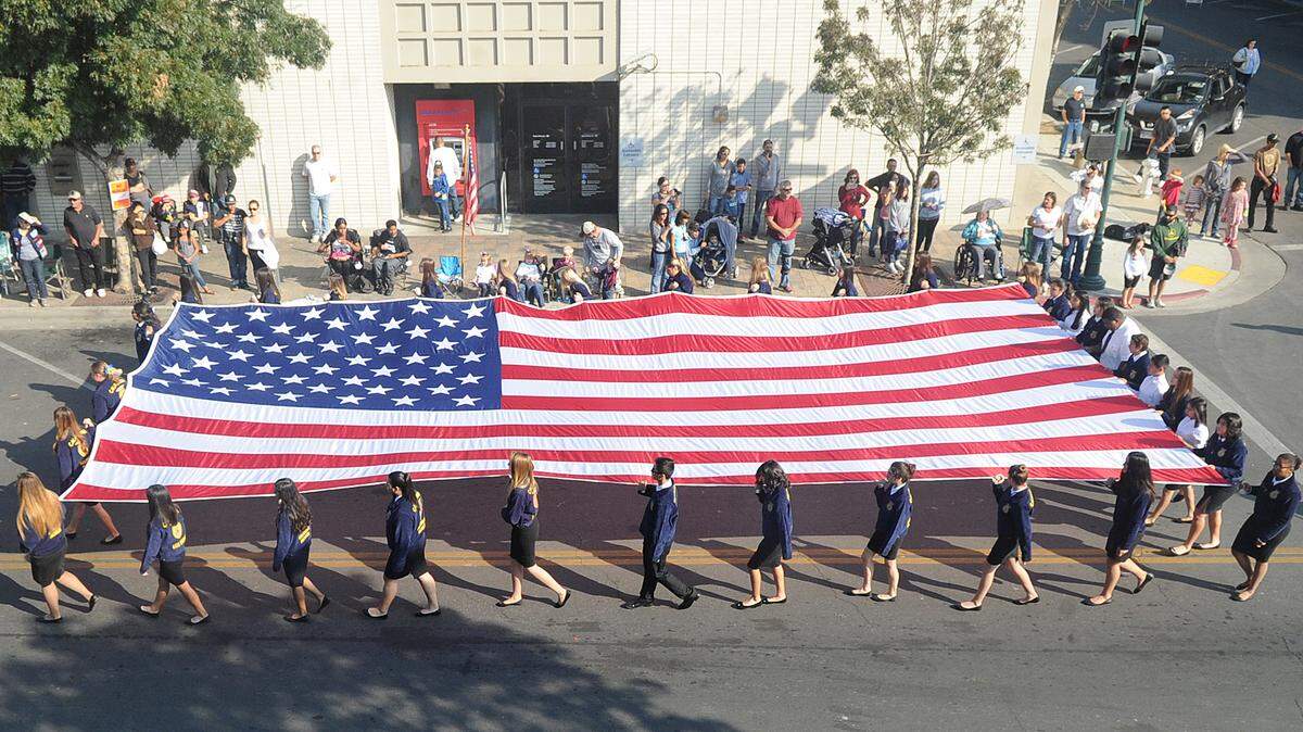 Future Farmers of America students from both Los Banos and Pacheco high schools carry the American flag at the beginnng of the Veterans Day Parade in Los Banos on Sat., Nov. 5, 2016.