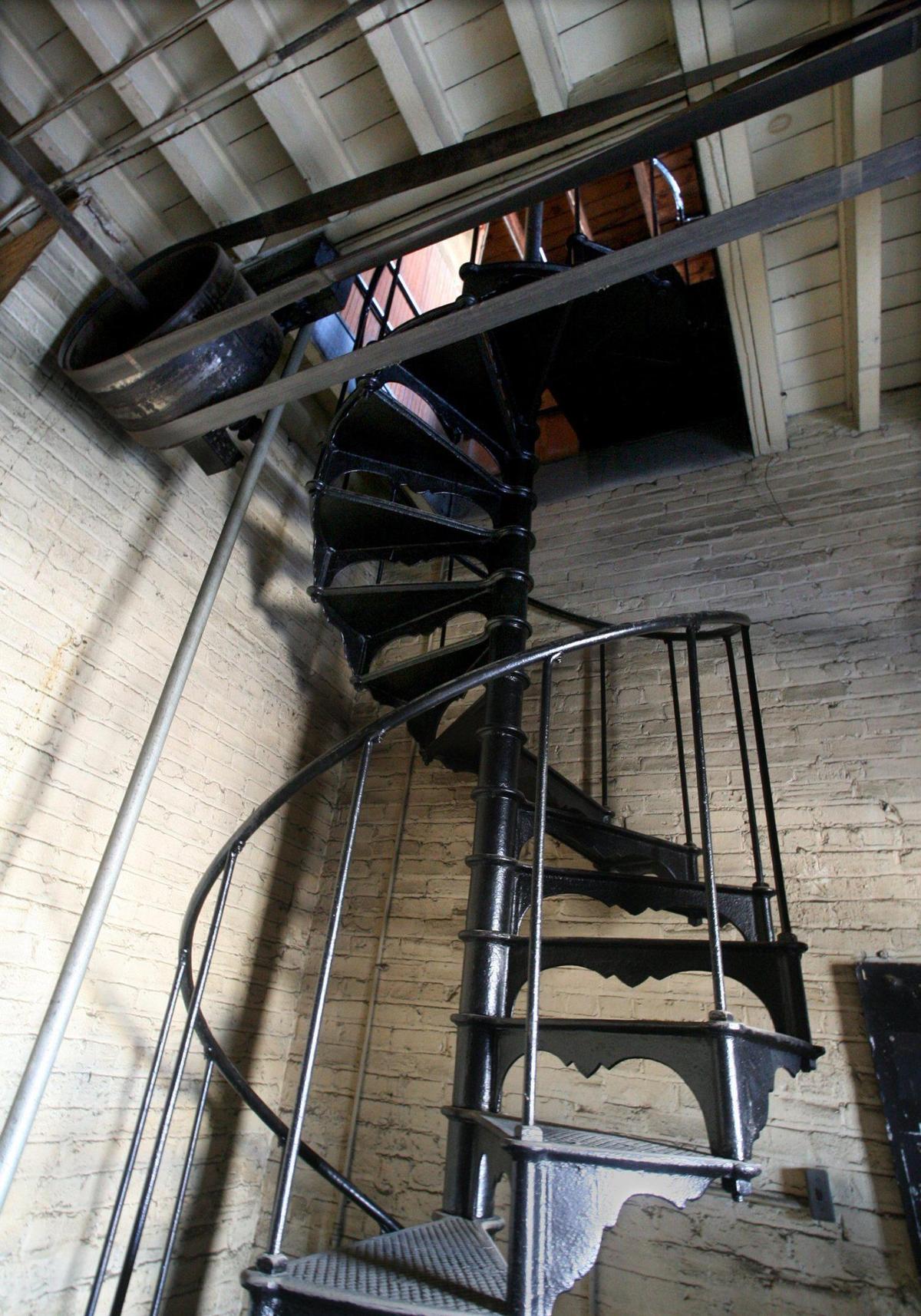 The iron spiral staircase, spanning three levels of the Fresno Brewing Co.’s mpany’s bottling works building which also houses the office, is pictured in this 2010 Fresno Bee file photo. At top is the belt driven pulley system to lift the elevator, out of view to right, which was originally powered by mules, when it was built in 1907.