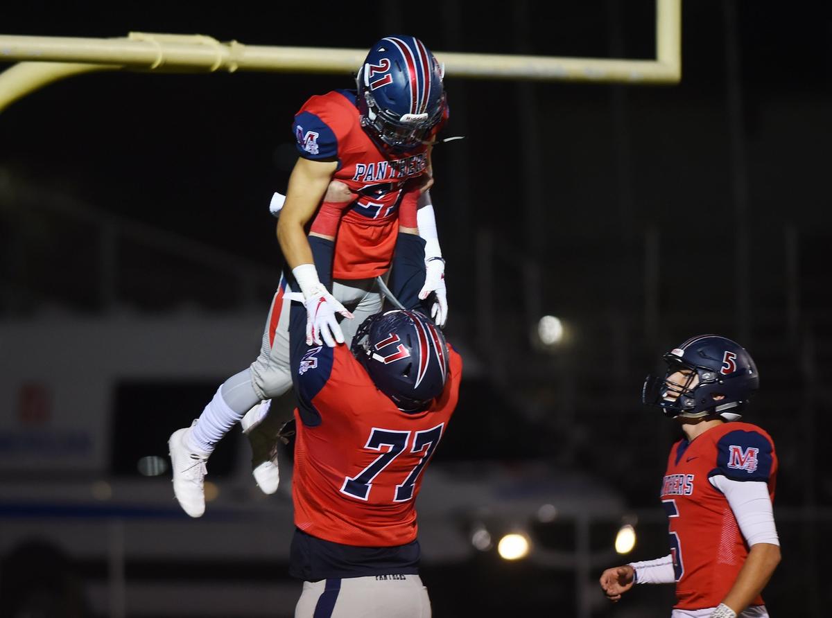 San Joaquin Memorial’s Konner Gomness, bottom, hoists running back Eric Hirata after he scores a touchdown against San Luis Obispo in the Central Section Division III playoffs Friday night, Nov. 9, 2018 in Fresno. San Joaquin Memorial led 57-3 at halftime and won 57-23.