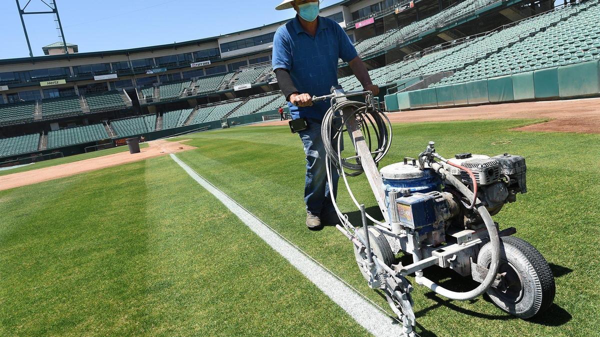 Fresno Grizzlies groundskeeper David Jacinto stripes Chukchansi Park’s third-base line, Monday May 10, 2021, in preparation for the team’s opener, Tuesday May 11, against the Visalia Rawhide.