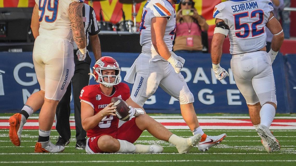 Fresno State quarterback Jake Haener sits on the turf after being sacked by Boise State during their game at Bulldog Stadium on Saturday, Nov. 6, 2021.