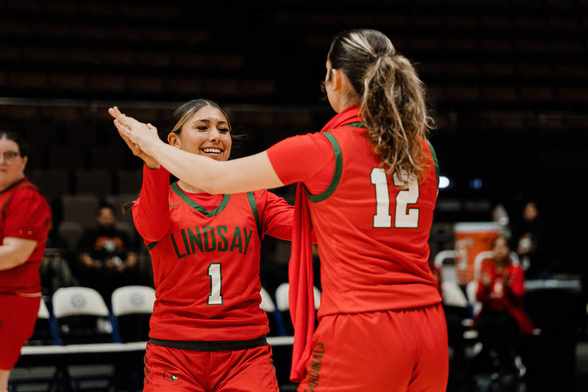 Lindsay’s Melanie Navarro, left, and Hailie Escobar celebrates on Friday, Feb. 28, 2025.