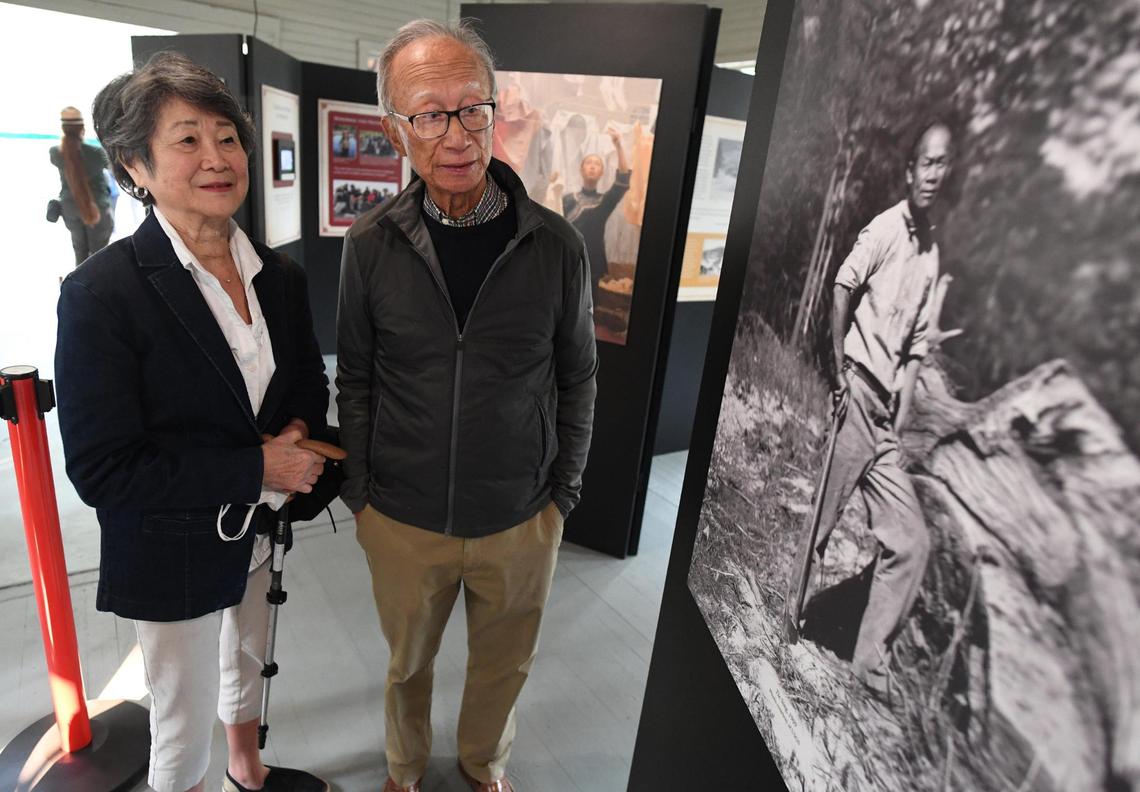Franklin and Sandra Yee from Sacramento, principal donors in the restoration of the 1917 Chinese laundry building at Wawona, which was dedicated Friday, Oct. 1,2021, look at a photograph of a Chinese laborer in an exhibit. The Yees have long family ties to Yosemite. The building was used as various things over the years and is being rededicated to tell the story of Chinese American contributions to Yosemite’s history.