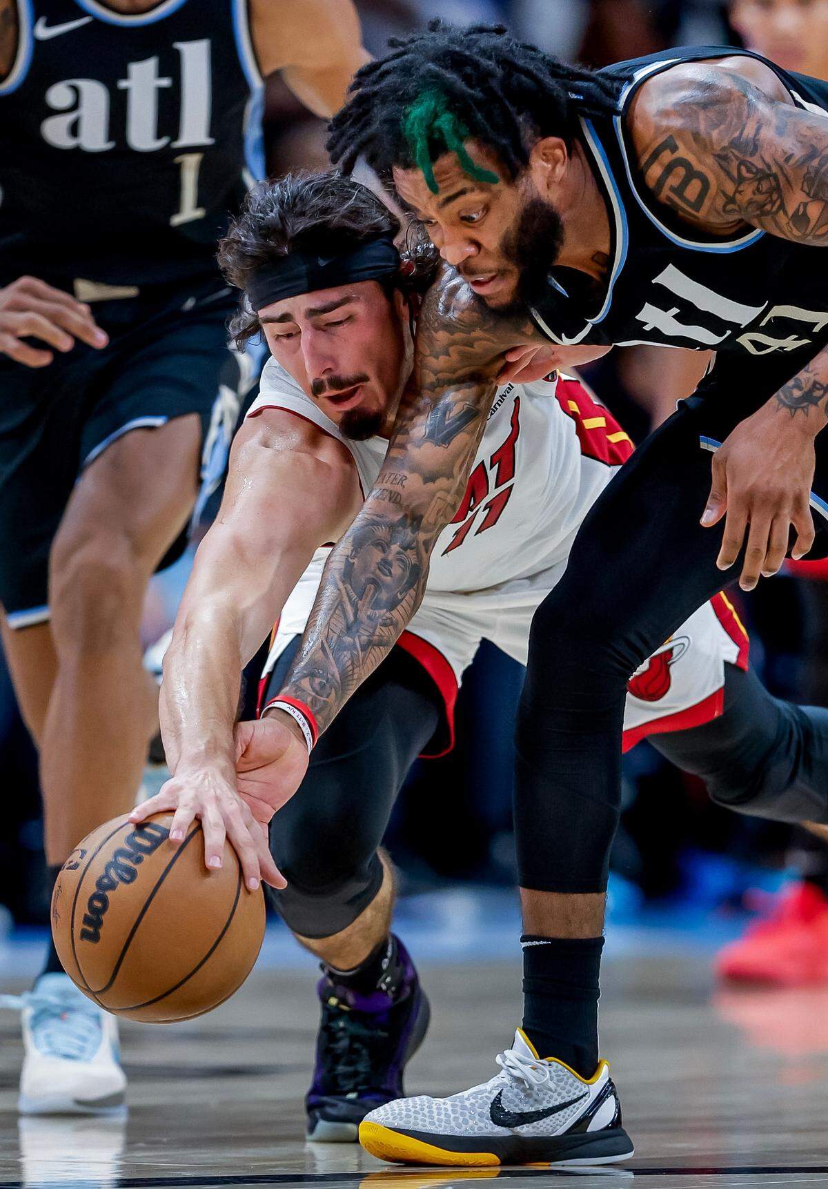 Miami Heat guard Jaime Jaquez Jr. (L) and Atlanta Hawks forward Saddiq Bey (R) battle for a loose ball during the first half of the NBA basketball game between Miami Heat and Atlanta Hawks in Atlanta on Nov. 11, 2023.