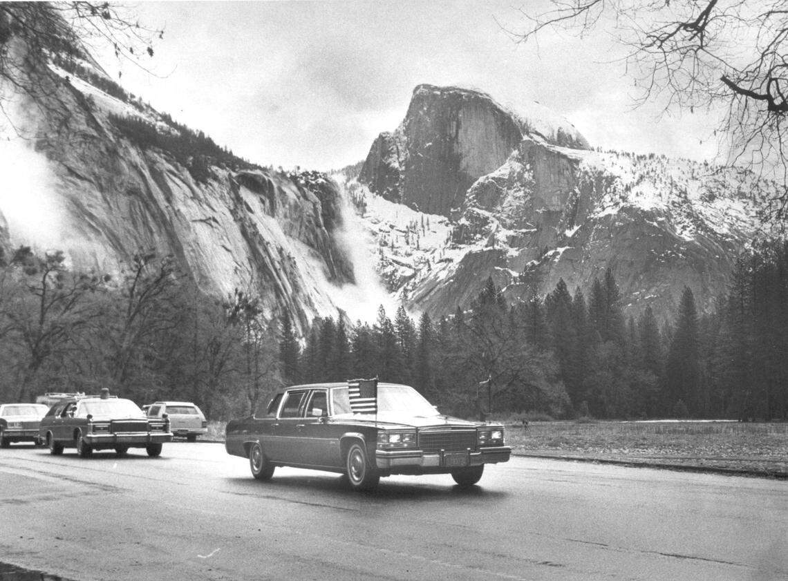 The royal motorcade travels out of Yosemite Valley under the snow-capped visage of Half Dome during Queen Elizabeth II’s 1983 visit to Yosemite National Park.