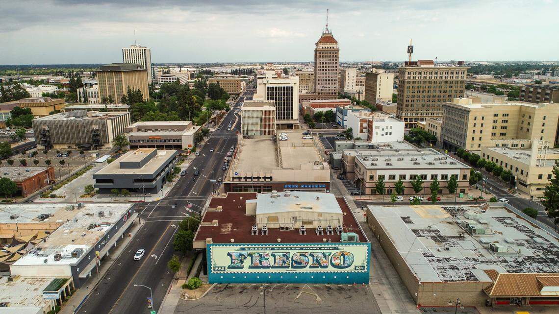The iconic Fresno postage stamp mural by late Fresno muralist FranCisco Vargas faces north, below center, with downtown Fresno behind it on Tuesday, May 30, 2023.