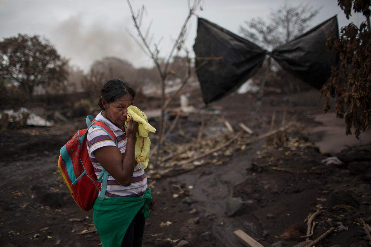 Eufemia Garcia cries near her house in San Miguel Los Lotes, Guatemala, where she lost more than 20 relatives who disappeared after the Volcano of Fire eruption.