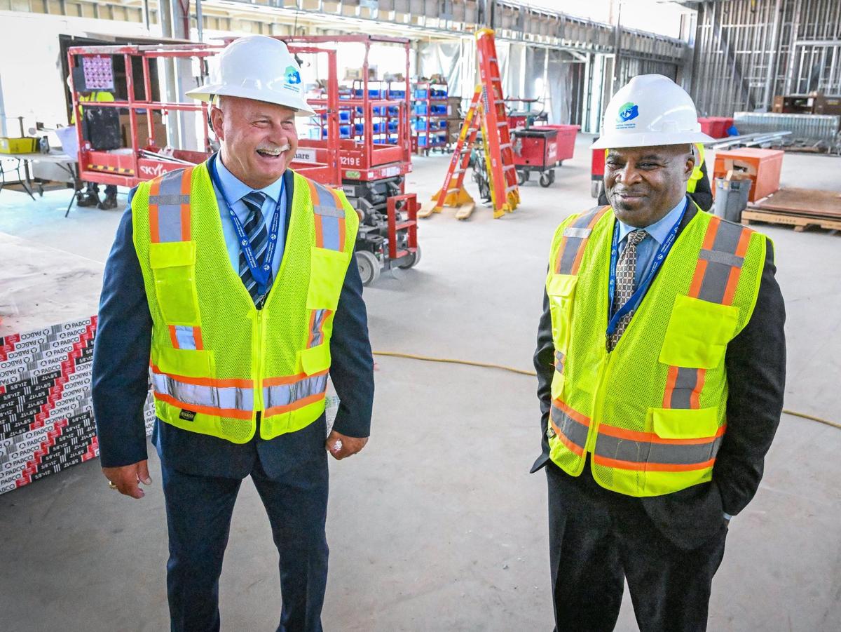 Fresno Mayor Jerry Dyer, left, and Fresno Yosemite International Airport Director of Aviation Henry Thompson share a laugh while touring the new terminal wing under construction at the airport on Wednesday, April 23, 2025.