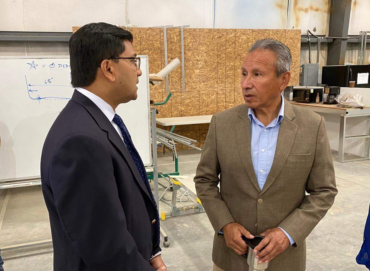 Amit Bose, left, adminstrator of the Federal Railroad Administration, talks with California High-Speed Rail Authority board member Henry R. Perea during a visit to a construction-industry training center in Selma, California on May 5, 2022.