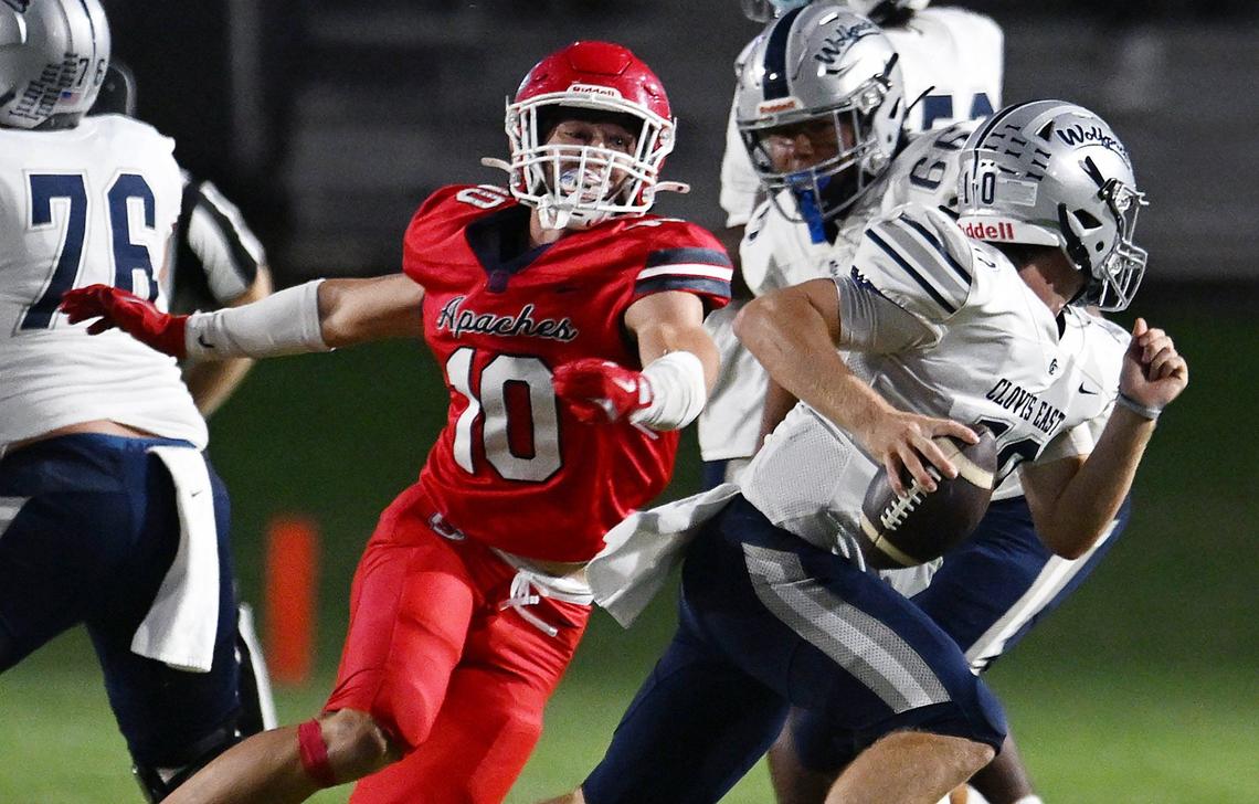 Sanger’s Cody Coles, left, pressures Clovis East quarterback Tyus Miller, right, Friday, Sept. 6, 2024 in Sanger. Final score, Clovis East 56, Sanger, 3.