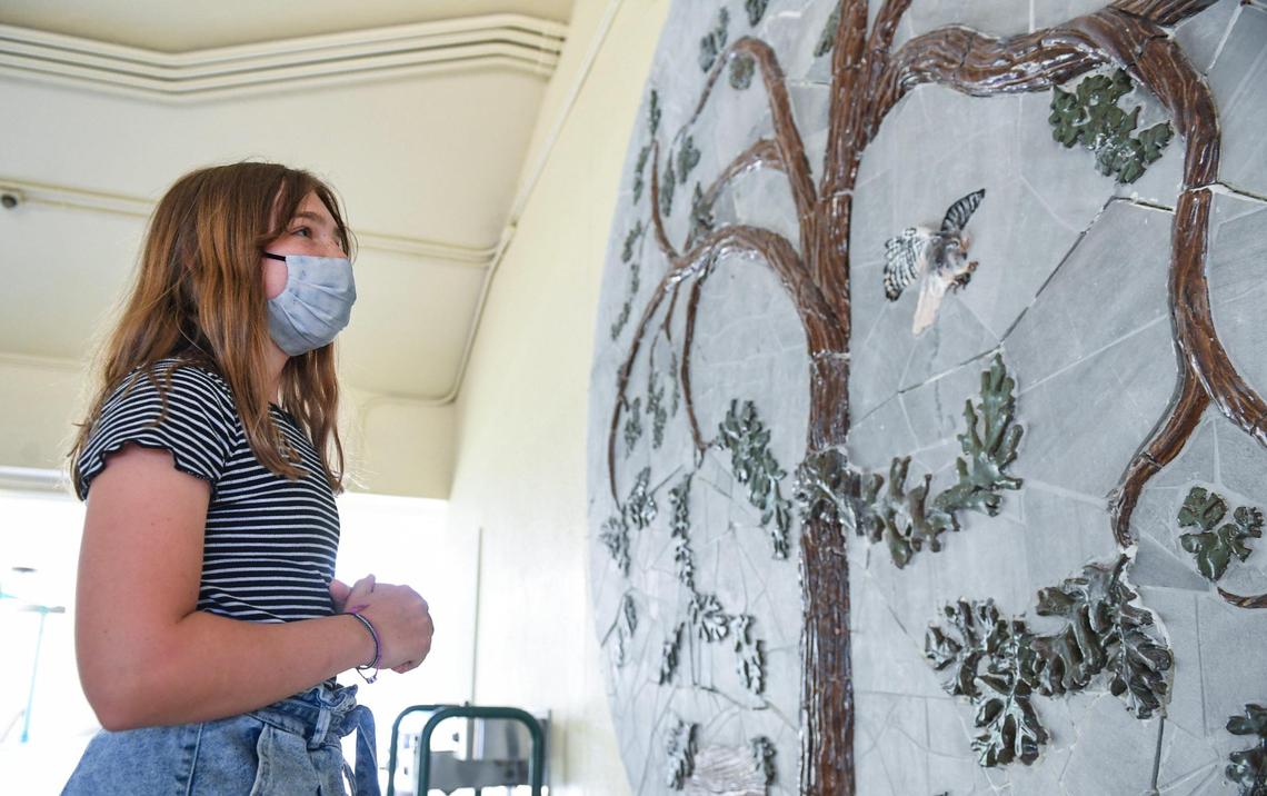 Sixth grader Keira Swain looks over the ceramic mural she helped create with artist David Roberts and fellow classmates at Manchester GATE Elementary School in Fresno, on Tuesday, June 1, 2021.