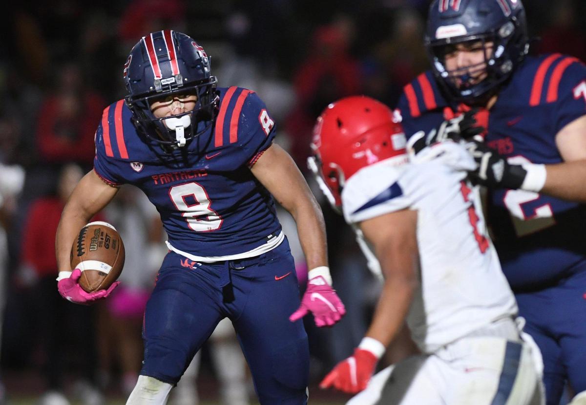 San Joaquin Memorial’s Brandon Ramirez, left, carries the ball against Sanger Friday, Oct. 28, 2022 in Fresno. Memorial dominated Sanger to a 56-21 championship win in the County/Metro Athletic Conference.