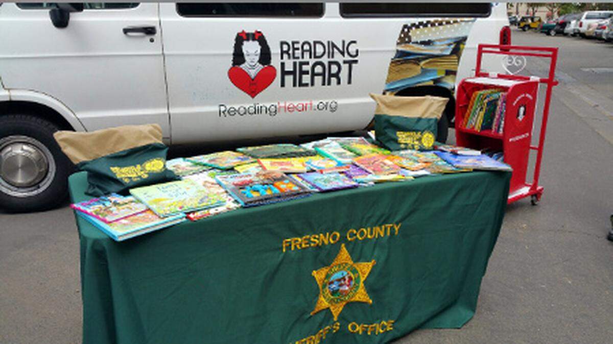Books offered by the Fresno County Sheriff’s Reading Posse. Also shown in a Reading Heart van. Reading Heart is a nonprofit, 501(c)(3) book donation program dedicated to serving children in hospitals and kids with limited access to books.