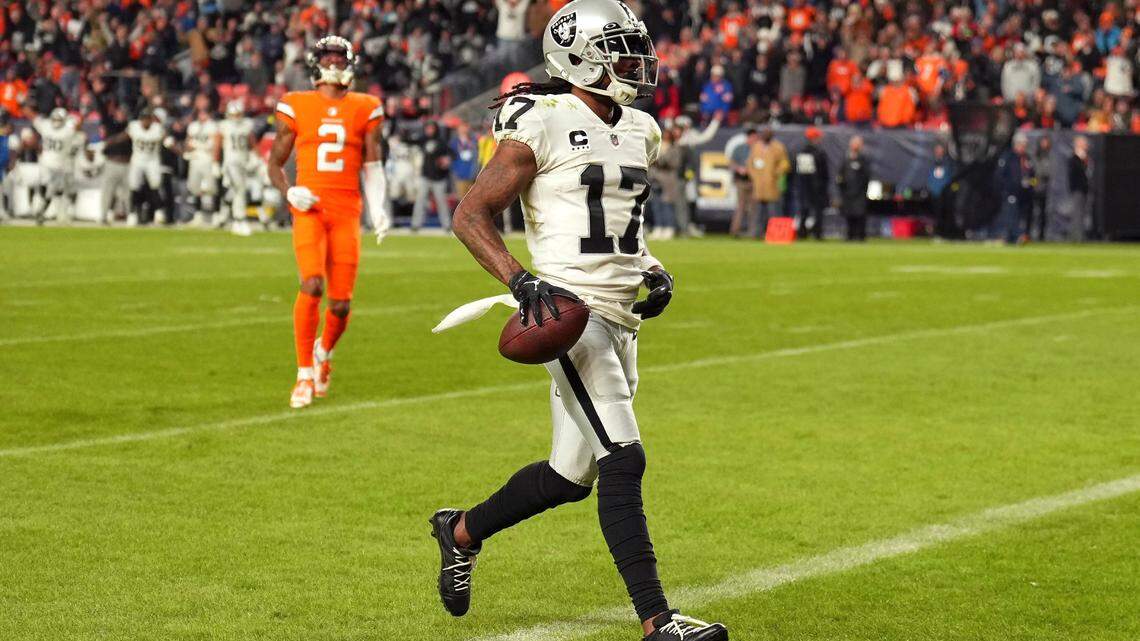 Las Vegas Raiders wide receiver Davante Adams scores the winning touchdown in front of Denver Broncos cornerback Pat Surtain II during overtime of an NFL game in Denver, Sunday, Nov. 20, 2022.