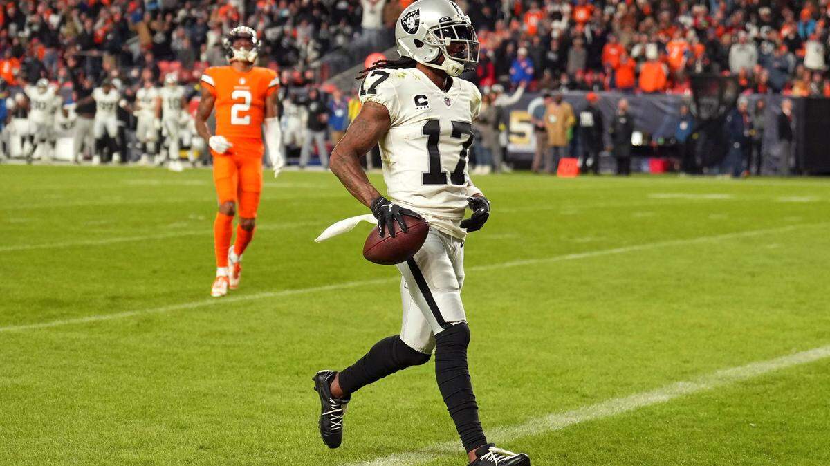 Las Vegas Raiders wide receiver Davante Adams scores the winning touchdown in front of Denver Broncos cornerback Pat Surtain II during overtime of an NFL game in Denver, Sunday, Nov. 20, 2022.