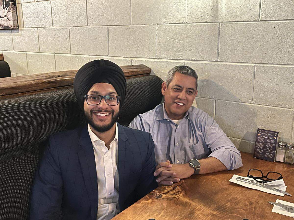 Fresno City Council candidate Nav Gurm, left, sits down with Fresno City Councilmember Miguel Arias at a June 2, 2026, election watch party at Sequoia Brewing Co. in Fresno.