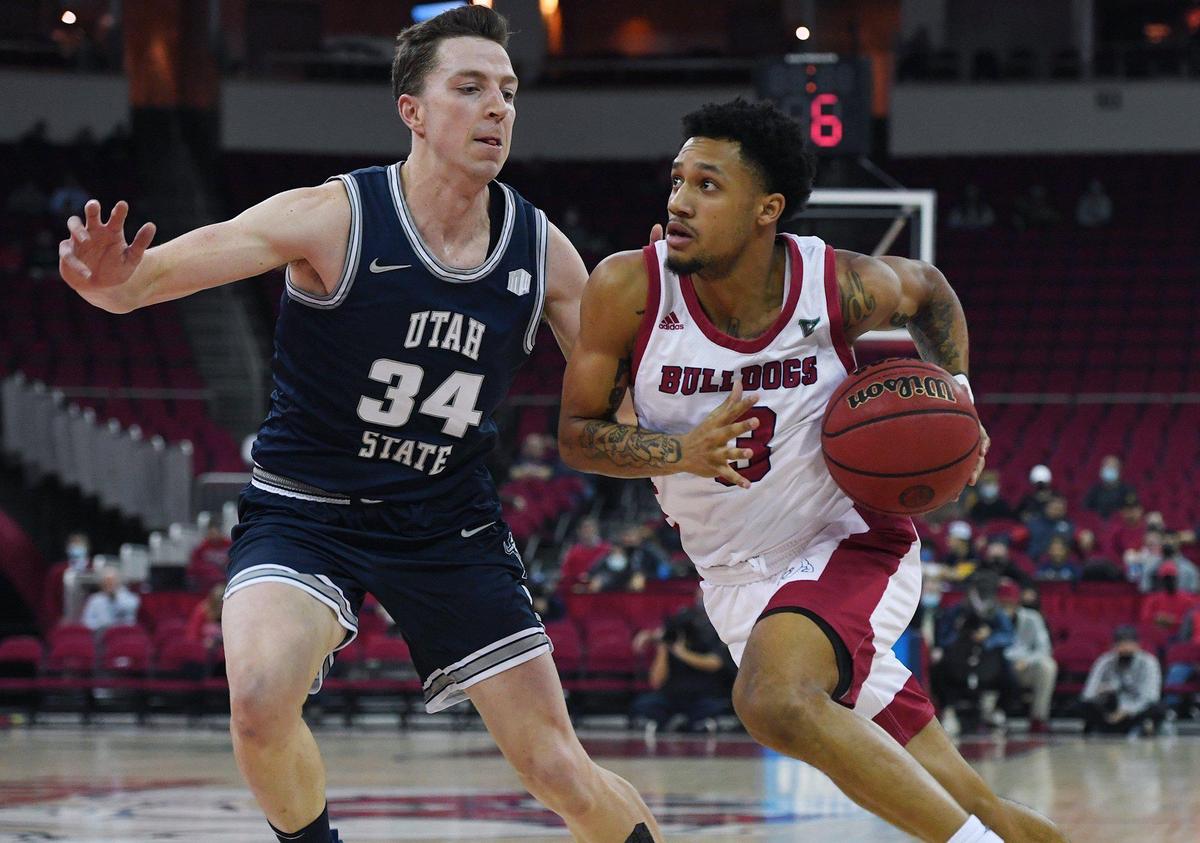 Fresno State point guard Isaiah Hill drives around Utah State’s Justin Bean, left, in the Bulldogs’ 61-54 victory over the Aggies Tuesday night, Jan. 18, 2022 in Fresno.