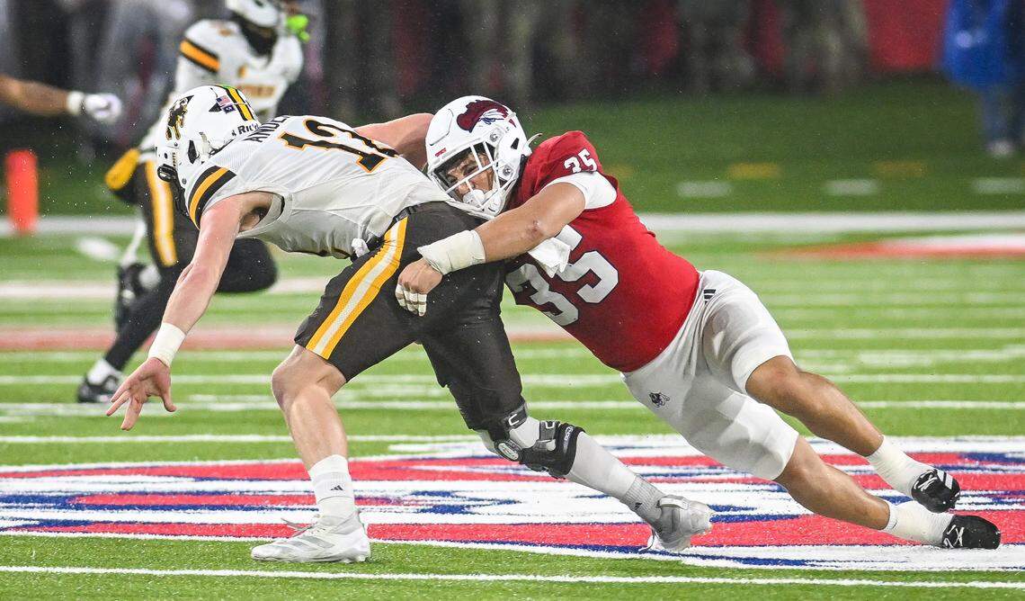 Fresno State’s Tytus Khajavi, right, brings down Wyoming quarterback Kaden Anderson for a sack during their game at Valley Children’s Stadium on Saturday, Nov. 16, 2025.