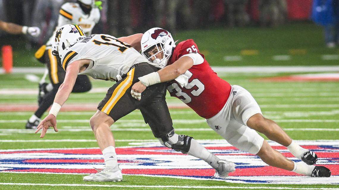 Fresno State’s Tytus Khajavi, right, brings down Wyoming quarterback Kaden Anderson for a sack during their game at Valley Children’s Stadium on Saturday, Nov. 16, 2025.