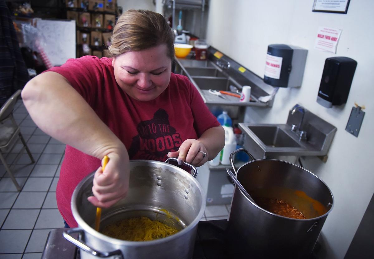 Tasha Valllejo makes rice pilaf as he husband Anthony Vallejo prepares chicken at Mega Texas Barbeque, located in an Arco gas station at Fresno St. and McKinley Ave. Thursday, Jan. 24, 2019 in Fresno.