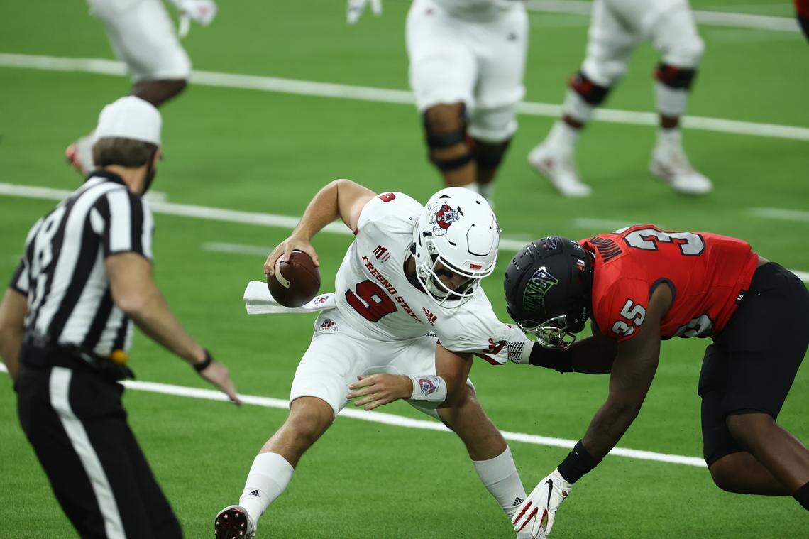 UNLV defensive lineman Jacoby Windmon pulls down Fresno State quarterback Jake Haener in the Bulldogs’ 40-27 victory over the Rebels at Allegiant Stadium, Saturday, Nov. 7, 2020.
