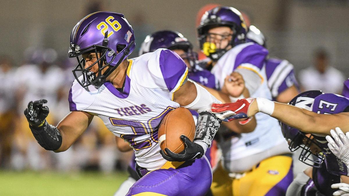 Lemoore’s andrew Hughes Moench busts through the line for a gain against Washington Union in their game at Washington Union on Friday, Aug. 26, 2022.