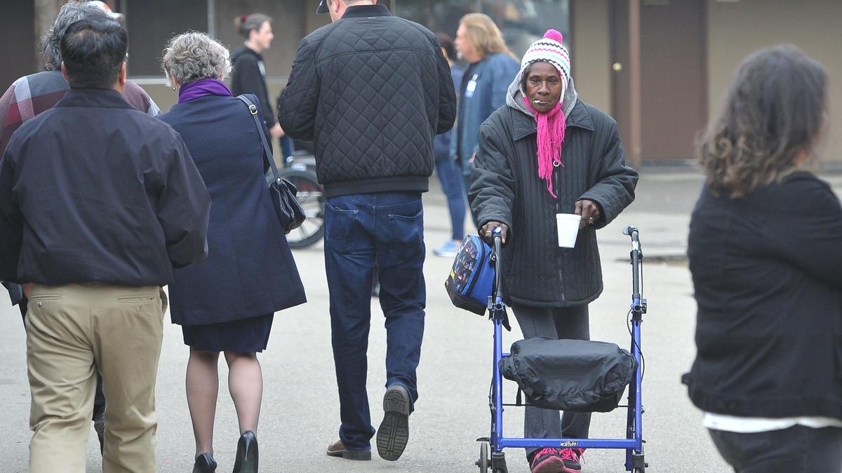 Mary Johnson, a resident of the RH Emergency Winter Warming Shelter, strolls the property as people tour the 77-bed facility aimed at ending homelessness, after grand opening ceremonies, Monday Jan. 6, 2020. RH Community Builders will provide housing and meals for 77 homeless individuals and families through February 2020, with the purpose of moving the residents from temporary shelter to a permanent housing solution during the operation period. Prevention strategies like rental stabilization and early intervention are needed to keep families housed.