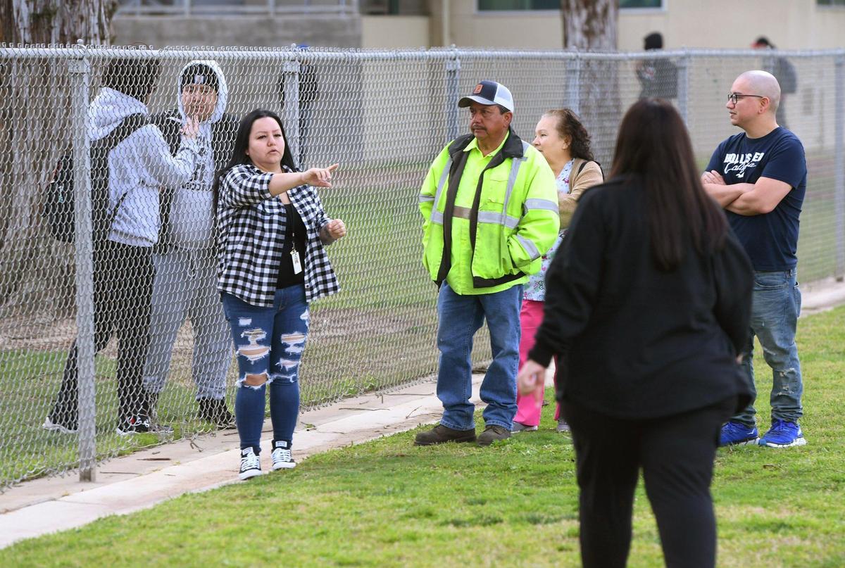 Concerned parents gather outside Herbert Hoover High School after a hoax call from outside the area forced a lockdown Friday around noon, March 24, 2023 in Fresno.