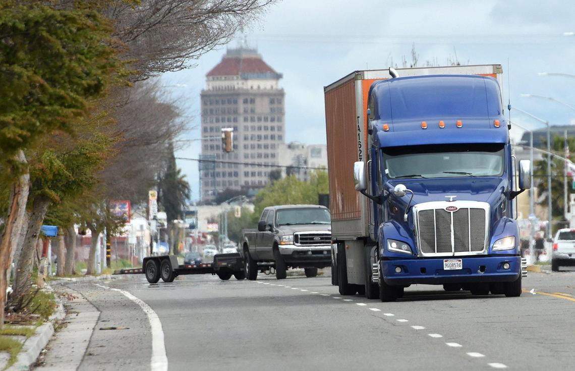 A semi truck heads south on Elm Avenue into a disputed area the city has plans for rezoning, March 10, 2021. Opponents against the city’s plan to rezone 92 acres, say the proposal will allow industries to expand, bringing in more truck traffic and with it, pollution in an area hit hard by asthma among residents.