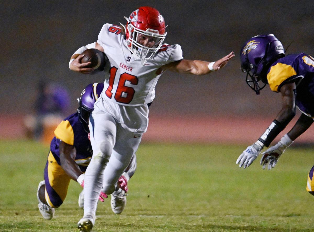 Sanger’s Marshall Pittman, center, eludes two Lemoore tackles Friday, Sept. 8, 2023 in Lemoore. Sanger dominated Lemoore in the 42-13 win.