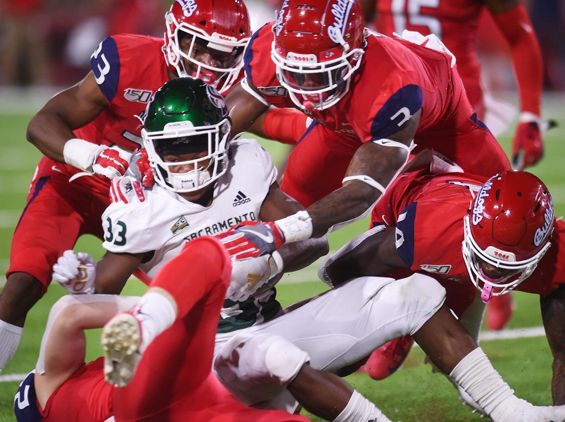 The Fresno State defense swarms over Sacramento State’s Elijah Dobson, center, Saturday, Sept 21, 2019 in Fresno.
