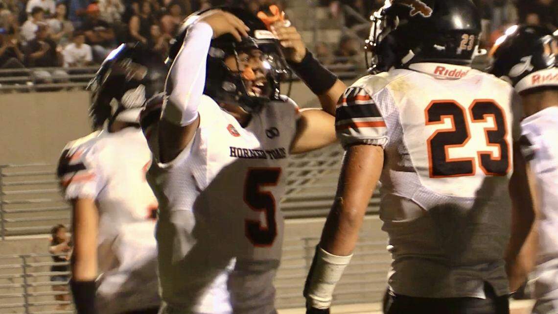 Coalinga High quarterback Noah Tasi congratulates Julius Borjas for scoring a rushing touchdown in a 37-24 victory over Washington Union on Friday, Sept. 27, 2024.