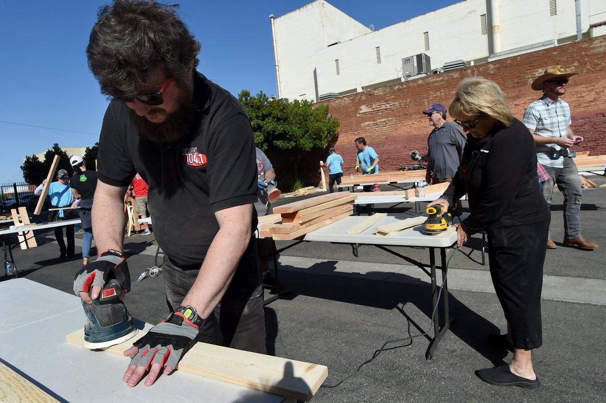 One Putt Broadcasting volunteer Michael Bonner works a sander as he joins about 40 others through the Fresno chapter of Sleep in Heavenly Peace on a Bunk Bed Build on Saturday morning, May 8, 2021. Ten bunks were built that will help 20 children in the Fresno and Clovis area who are without beds