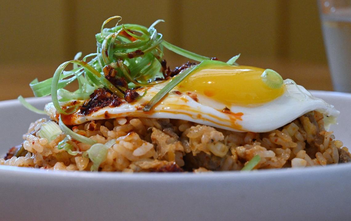 Yolked Kitchen’s Breakfast Fried Rice includes kimchi, braised pork shoulder, green onions, soy sauce, chile crunch and a fried egg. Photographed Thursday, July 11, 2024 in Clovis.