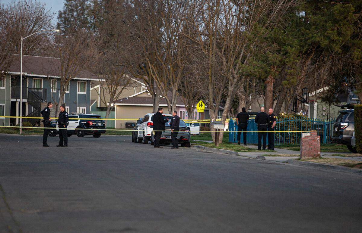 Police tape of the street as they investigate a shooting that left a woman shot eight times in a southwest Fresno neighborhood on Monday, Feb. 28, 2022.