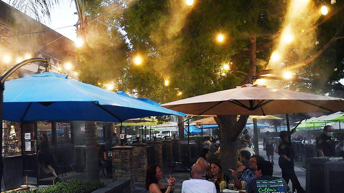 Misters and lights make outdoor dining comfortable at Colton’s Social House, which was expanded into the parking lot. The changes attracted plenty of customers during the summer of 2020 in this Fresno Bee file photo. Now, the restaurant has removed 20 of its 30 outdoor tables.