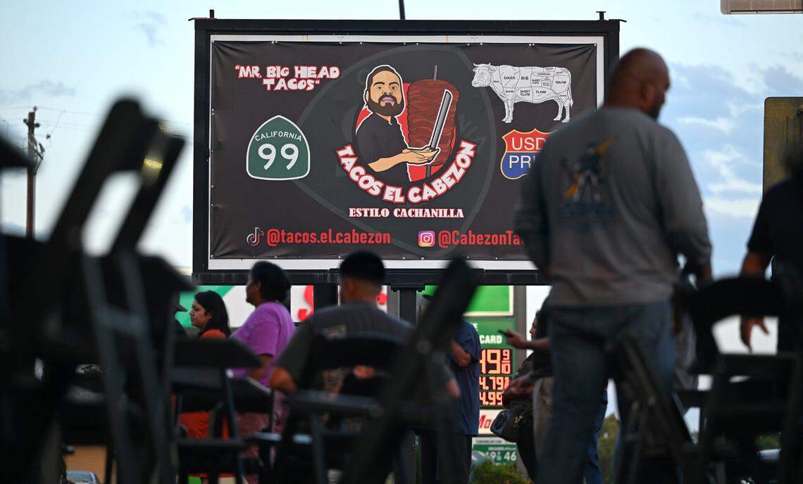 A large billboard sign promotes the nearby Tacos El Cabezon, a food truck at the corner of Shaw and Maroa avenues featuring Armando Arias Jr.’s Mexicali-style food. Photographed Wednesday, Sept. 24, 2025 in Fresno.