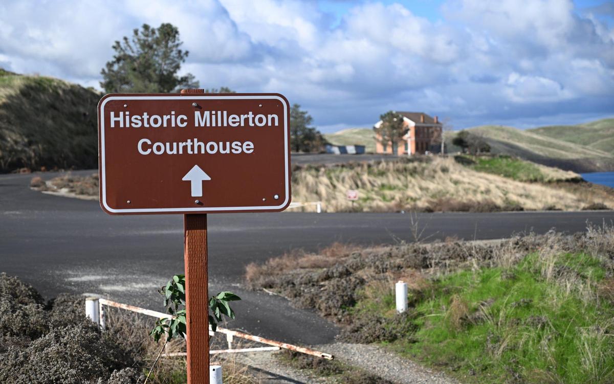A sign points visitors to a replica of Millerton Courthouse, Fresno County’s original courthouse, seen at Millerton Lake Tuesday, Jan. 23, 2024 near Friant, California.