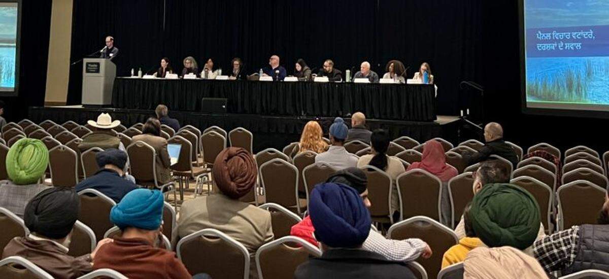 Nearly a dozen representatives of various California state agencies make presentations to a group of Punjabi American farmers in Visalia Dec. 4.