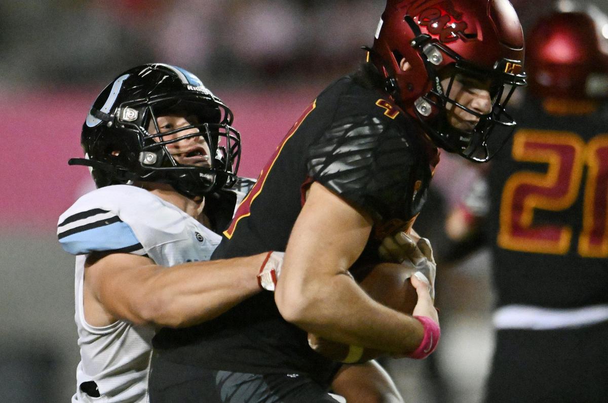 Clovis North’s Ross Cinfel sacks Clovis West quarterback Tyler Patrick in TRAC action Friday, Oct. 13, 2023, in Clovis. The game was tied 14-14 at halftime.