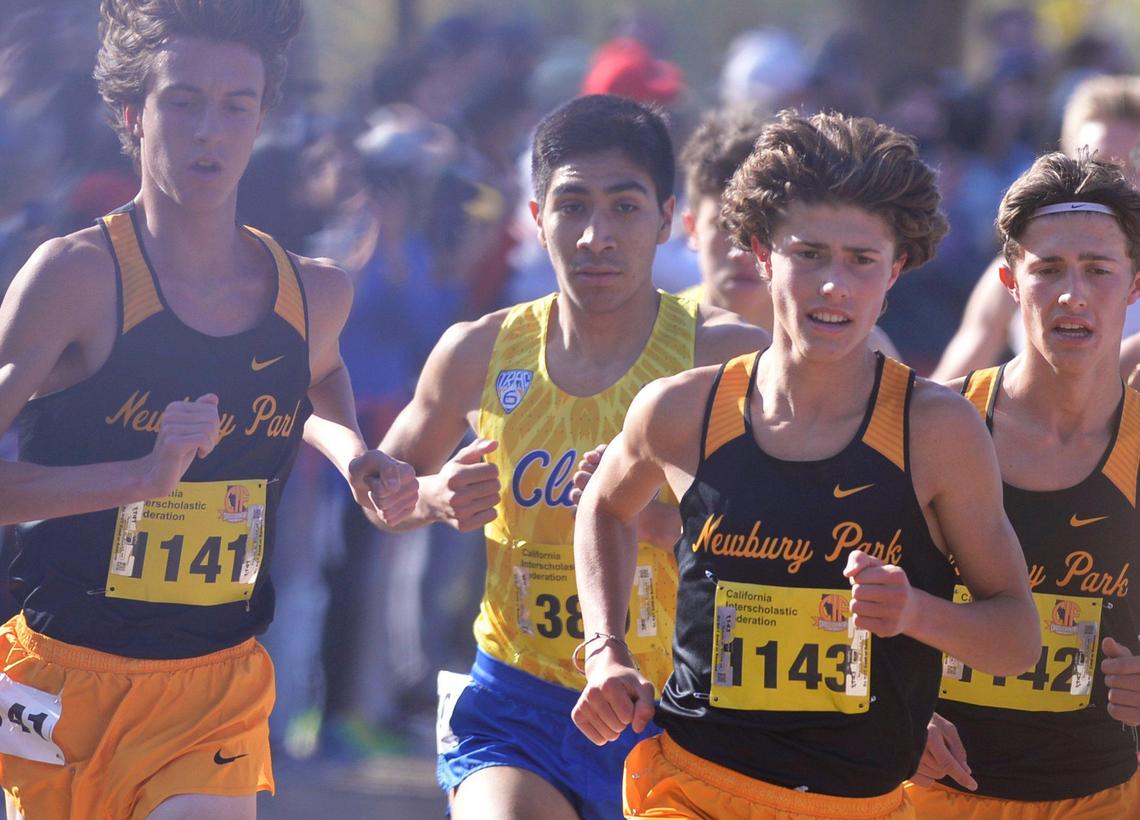 Clovis High’s Nathaniel Avila, second from left, runs behind runners from Newbury Park in the Division I race at the CIF state cross country championships held at Woodward Park Saturday, Nov. 27, 2021 in Fresno.