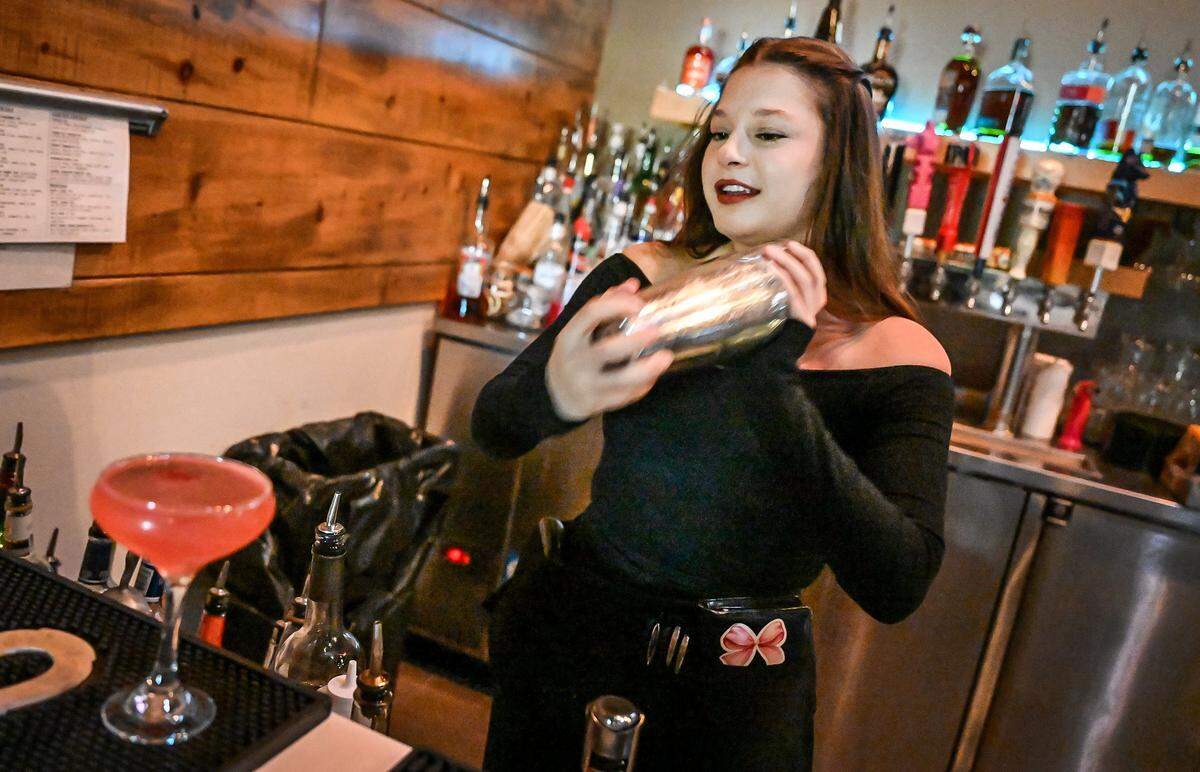 Ten Tavern server Sam Hugues mixes cocktails at the establishment's Willow and Nees location in Clovis on Tuesday, May 19, 2026. Ten Tavern is one of several local restaurants that offer a “girl dinner” option on their menu for a limited time. Ten Tavern's girl dinner includes a cocktail choice between a “Tentini” made with raspberry and Champagne, an espresso martini or a dirty martini.