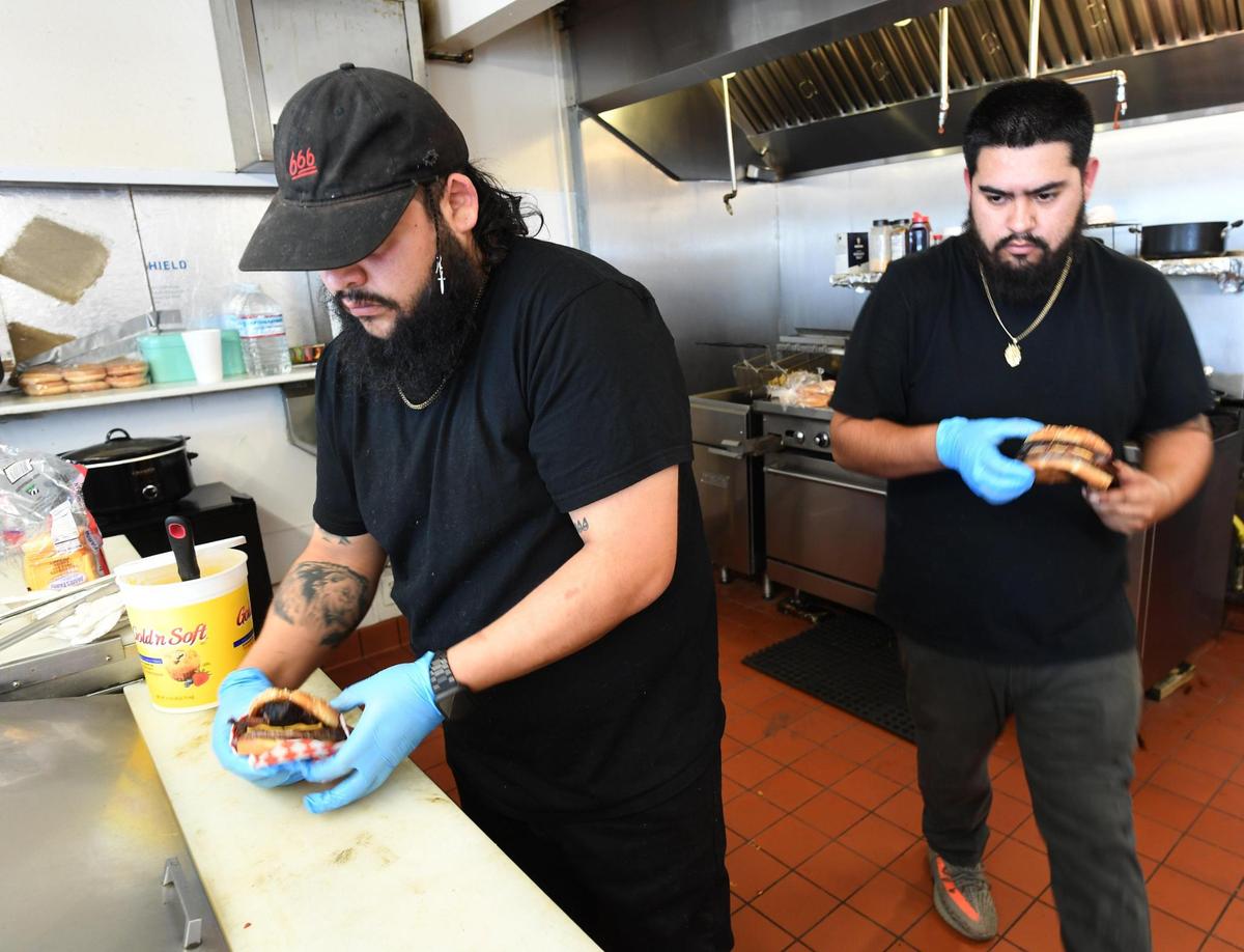 Hotbox BBQ owners Ivan Matamoros, left, and Esteban Guiverra, left, at their place inside the Valero gas station at Shields and Maple avenues.