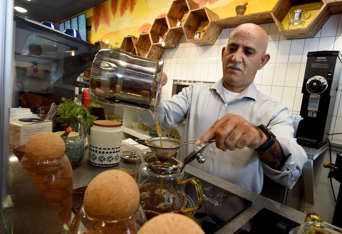Amidst jars of spices, Yemen native Ahmed Ghazaly prepares a cup of organic coffee, called mufawar, at his Bab-Al-Yemen Cafe. Each cup is prepared individually in a metal pot on a stovetop, with all kinds of flavors and spices, such as cardamom, ginger, and cinnamon, and hundreds of years of tradition.