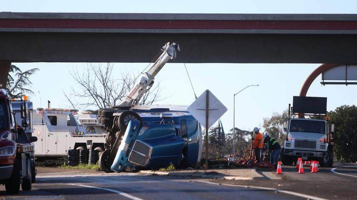 A truck flipped over on the transition of westbound Highway 180 and southbound Highway 99 in Fresno, CA, Feb. 17, 2019. A portion of the highway remained closed for a portion of the day.