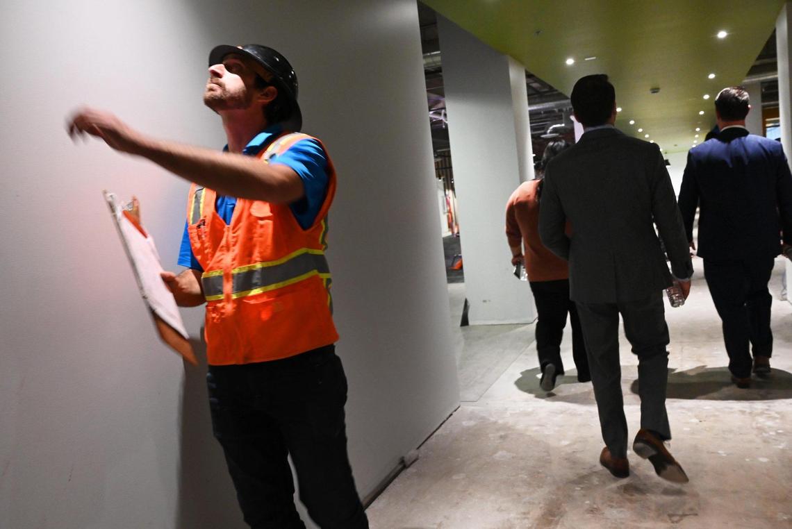 A worker checks a light fixture as a tour is held for The Fresno Mission’s new Heartbeat Hub Wednesday, Oct. 12, 2022 in Fresno.