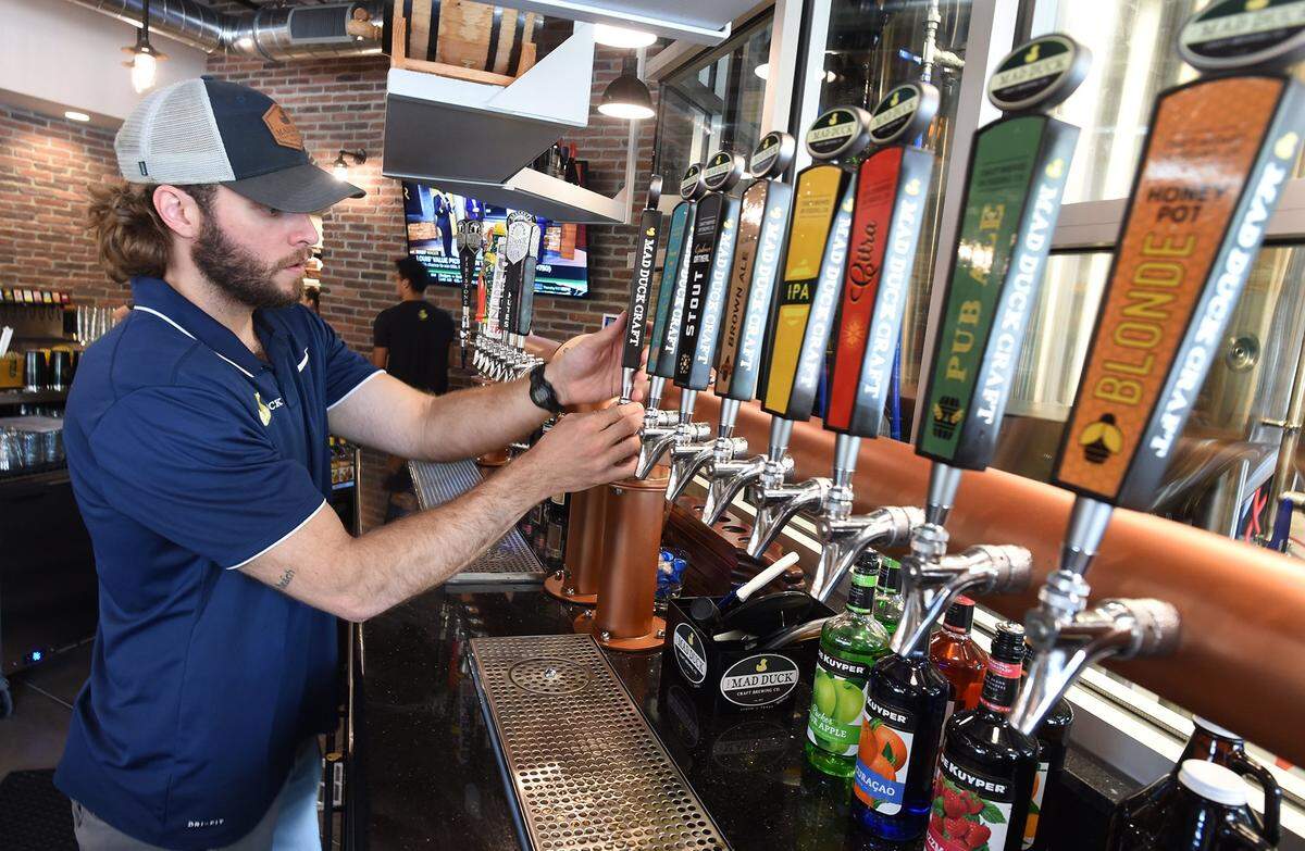 Mad Duck Craft Brewing Company assistant bar manager Ken Rogge gets the taps ready in this file photo from 2019.