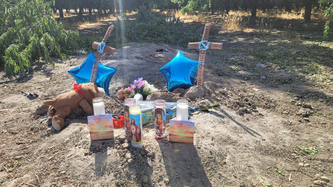 A memorial was in place Sunday afternoon at Marks and North Avenues, near the scene of a deadly crash Saturday, May 1, 2021, that left a father and his young son dead and another man facing manslaughter and DUI charges in Fresno County, California.