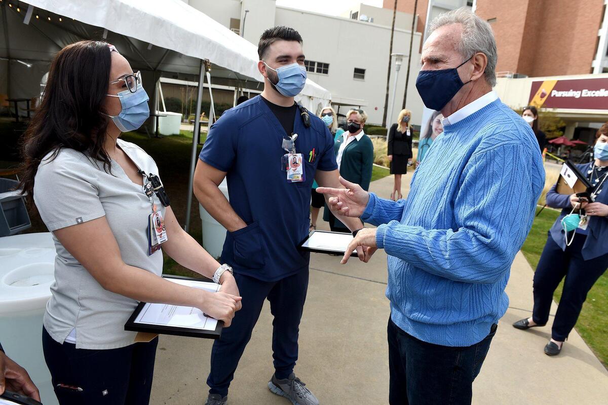 Prominent Fresno defense attorney Tony Capozzi, right, thanks Community Regional Medical Center RNs Connie Nies and Jacob Espinoza after they were presented recognition awards Tuesday, Feb. 23, 2021, through the hospital’s Honor Your Care Hero. Capozzi honored the medical staff for his recent treatment for a rare life-threatening condition.